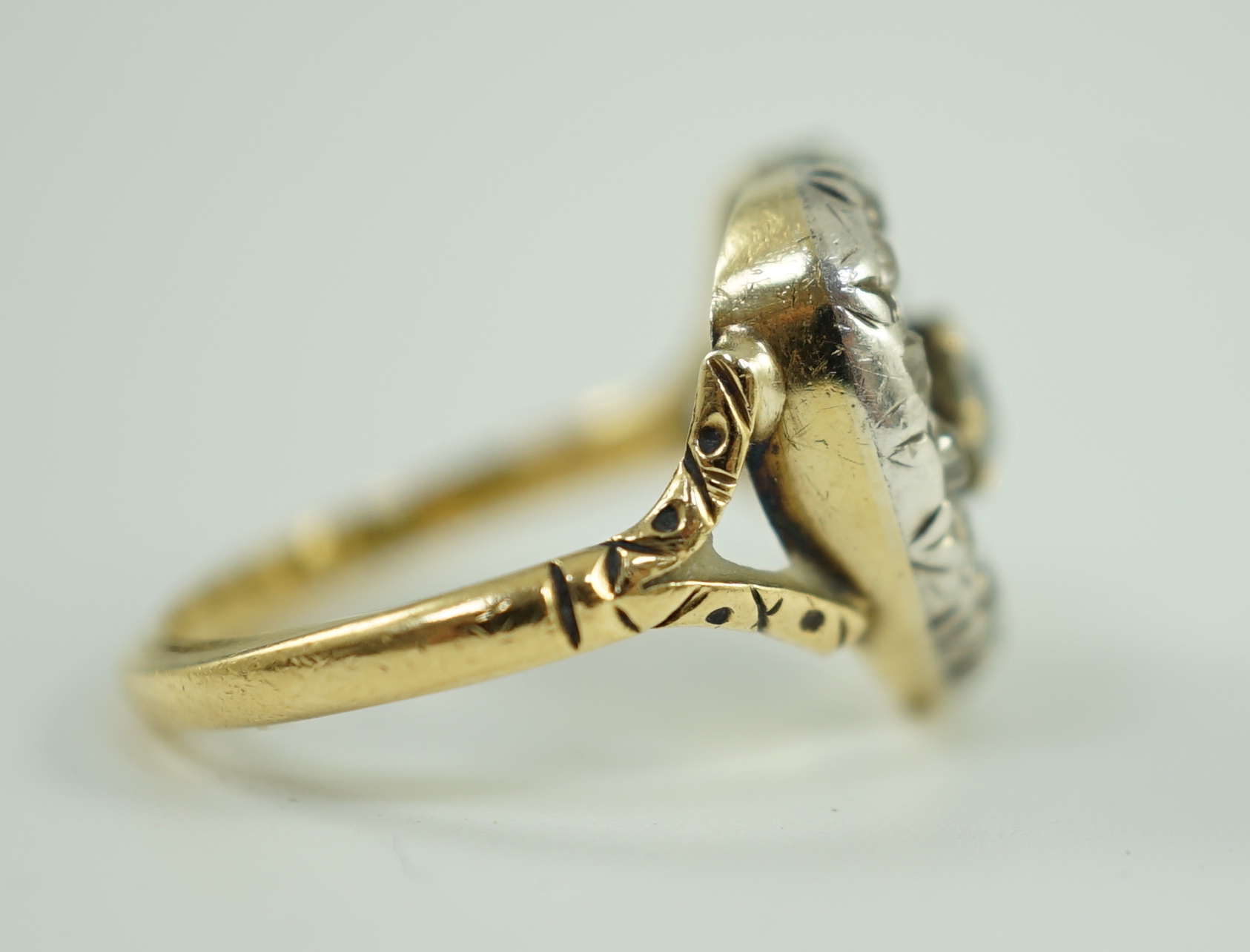 An antique gold and diamond set heart shaped open work cluster ring